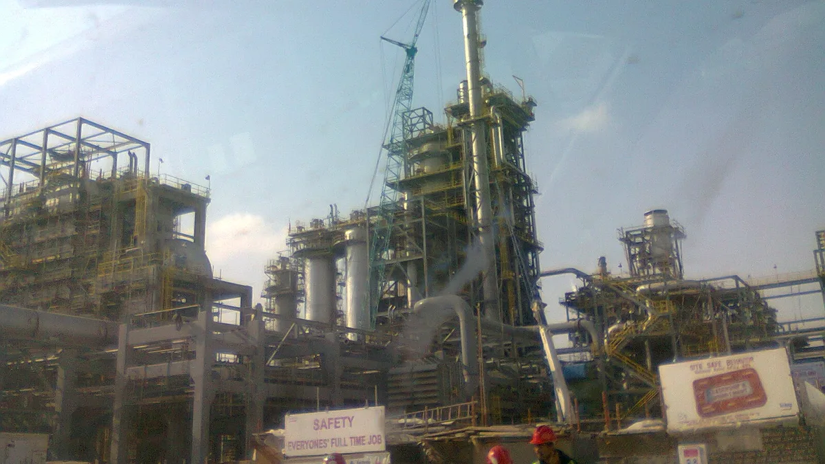 Flare stacks and pipework at an oil refinery