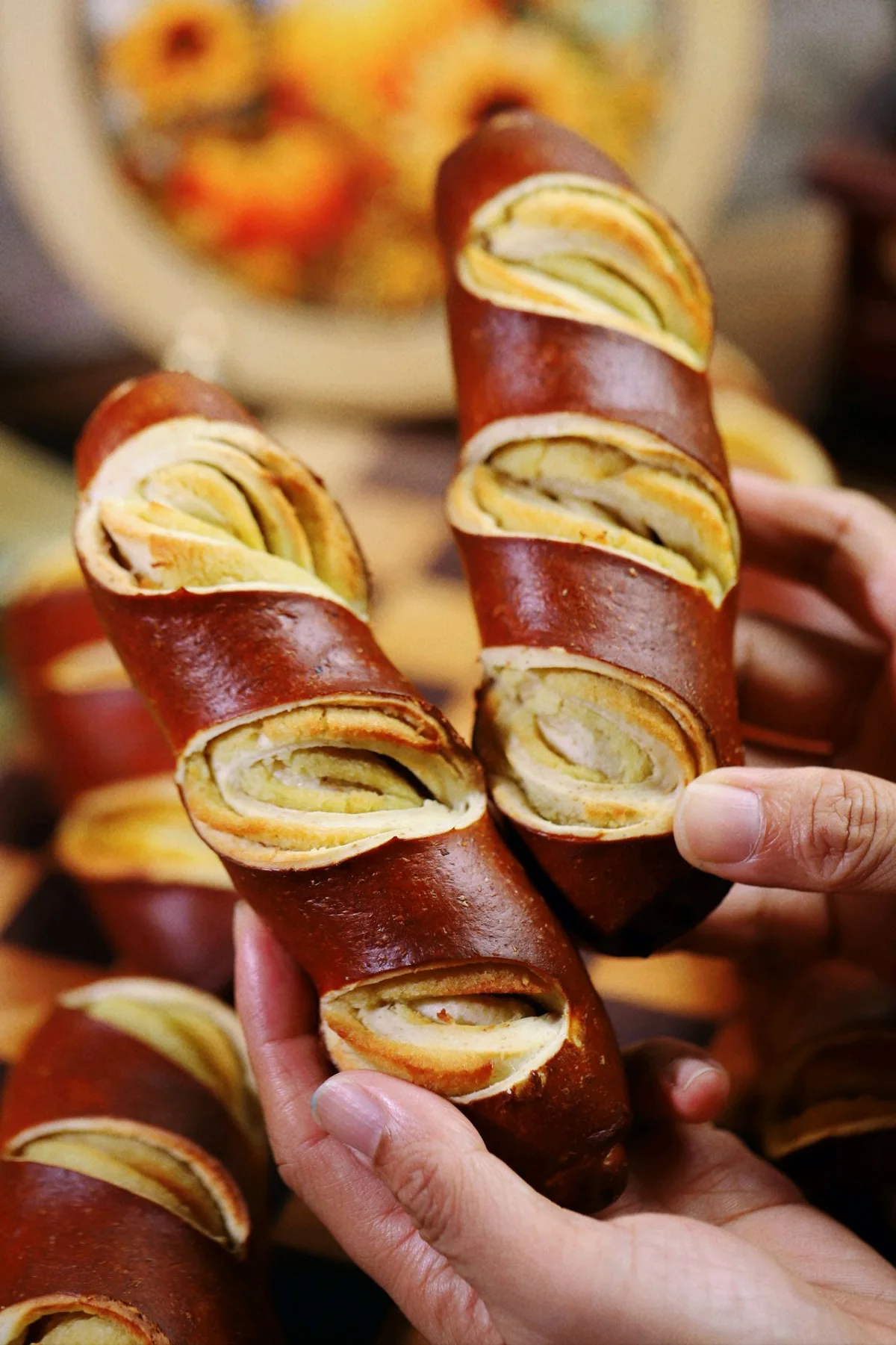 Dark brown lye breadsticks split open to show a sweet coconut filling