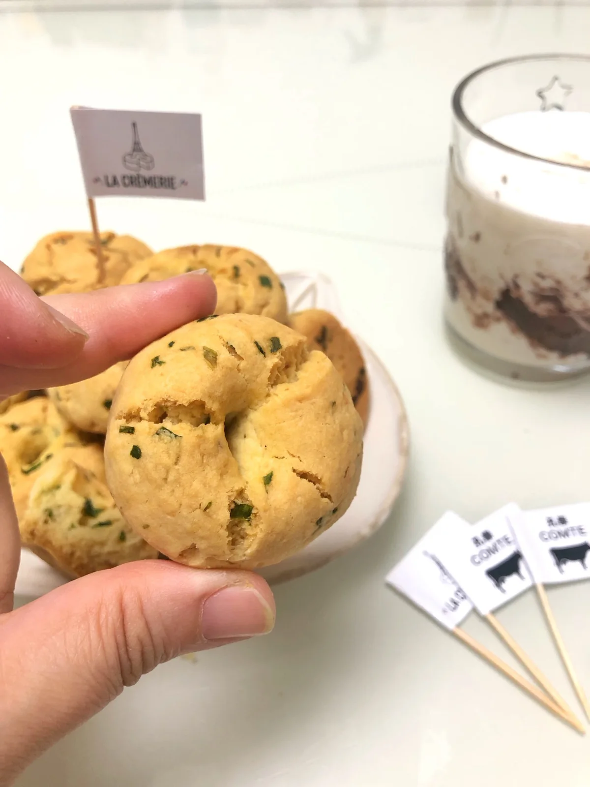 Savoury cheese and scallion cookies with dented centres on a plate