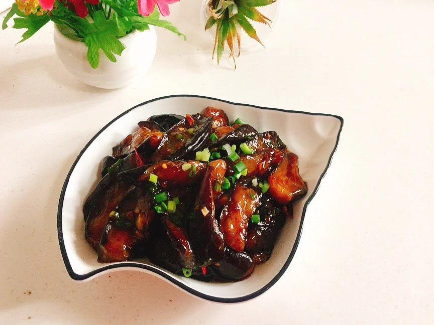 Glossy red braised eggplant chunks coated in dark sauce with garlic and chili
